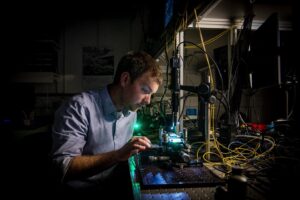 Photo of man working in a darkened laboratory